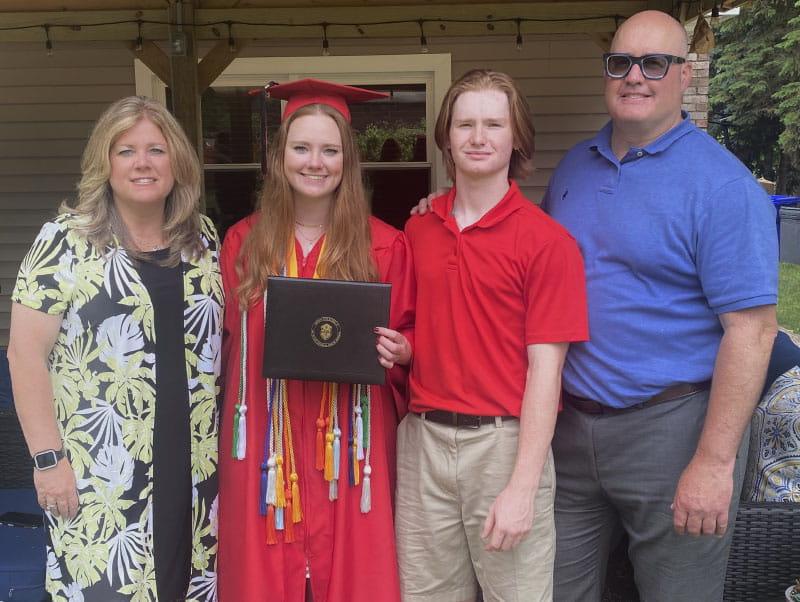 Maddy Ferriter with her parents and brother at her high school graduation. From left: John, Evan, Maddy and Kim. (Photo courtesy of the Ferriter family)