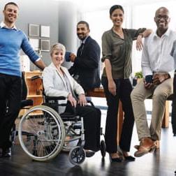 group of racially and gender diverse office workers smiling for camera